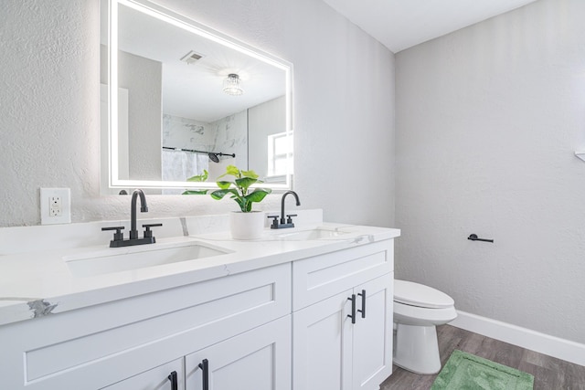 1111 Robinson St, Alvin, TX 77511 - bathroom with double vanity, curtained shower, and wood finished floors