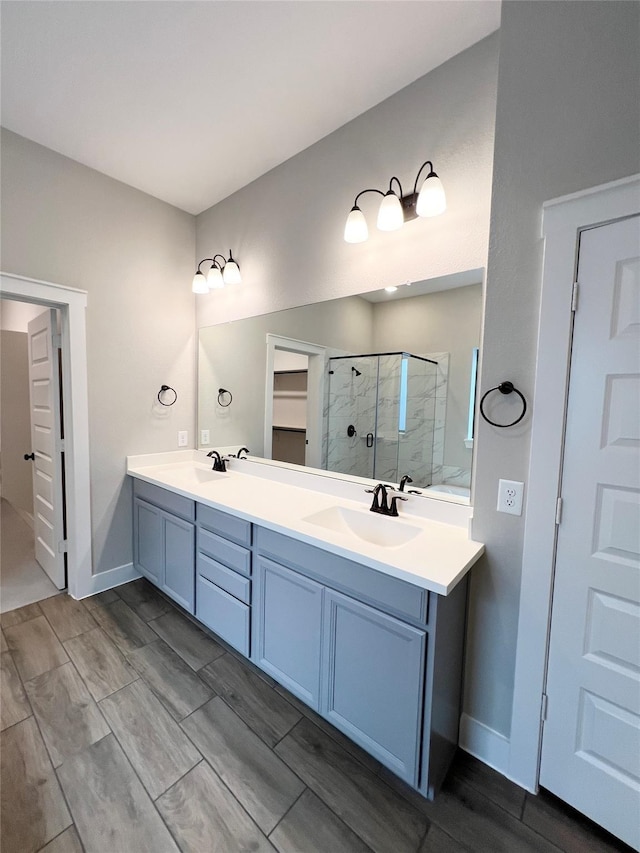 18518 Parkland Xing, Cypress, TX 77433 - bathroom featuring a shower stall, double vanity, and wood finish floors