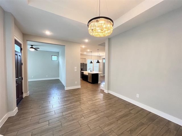 18518 Parkland Xing, Cypress, TX 77433 - unfurnished living room with wood finished floors, a chandelier, recessed lighting, and ceiling fan