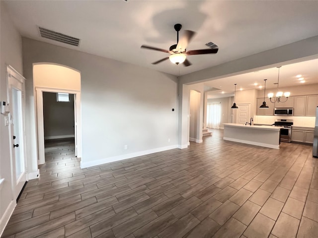 18518 Parkland Xing, Cypress, TX 77433 - unfurnished living room with a ceiling fan, arched walkways, dark wood finished floors, and recessed lighting