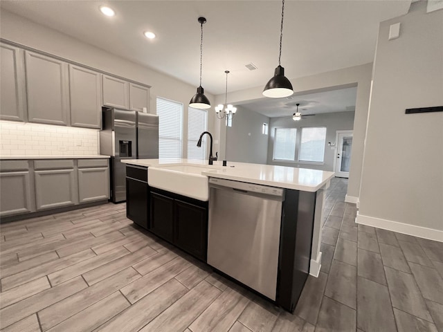 18518 Parkland Xing, Cypress, TX 77433 - kitchen with stainless steel appliances, light countertops, wood tiled floors, tasteful backsplash, and recessed lighting