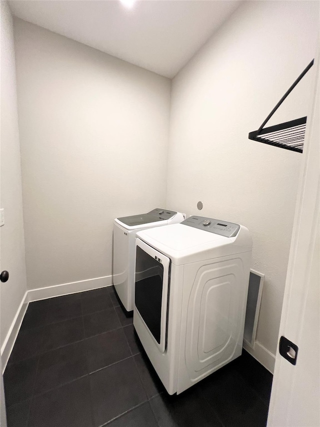 18518 Parkland Xing, Cypress, TX 77433 - washroom with washing machine and dryer and dark tile patterned floors