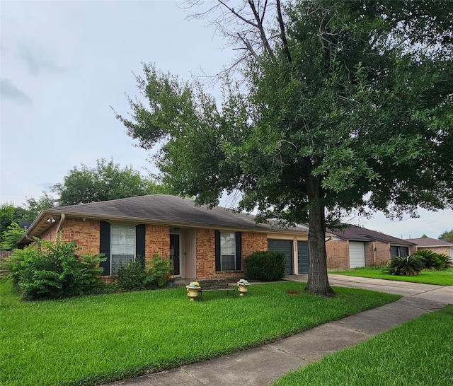19423 Quiet Brook Dr, Houston, TX 77084 - ranch-style house featuring a front yard, brick siding, an attached garage, and concrete driveway
