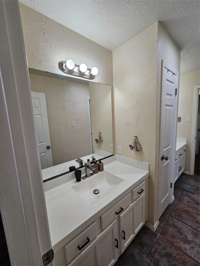 19423 Quiet Brook Dr, Houston, TX 77084 - bathroom with a textured ceiling, vanity, and a textured wall