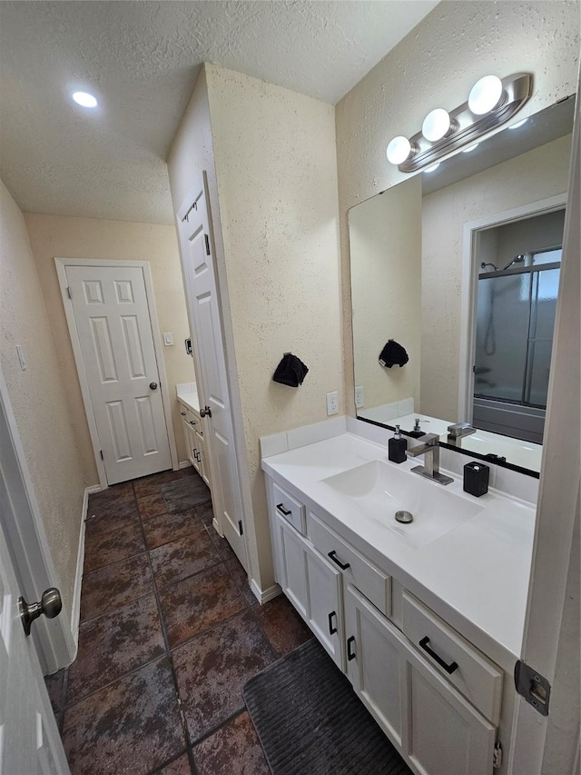 19423 Quiet Brook Dr, Houston, TX 77084 - full bath featuring vanity, a textured wall, a textured ceiling, and a shower with shower door