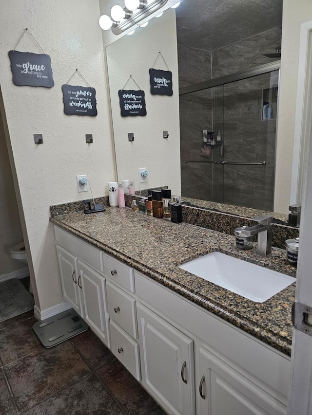 19423 Quiet Brook Dr, Houston, TX 77084 - full bathroom with vanity, a stall shower, and stone tile flooring