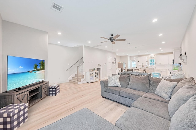 807 Ave J Pl, Conroe, TX 77301 - living room featuring stairway, recessed lighting, light wood finished floors, and ceiling fan