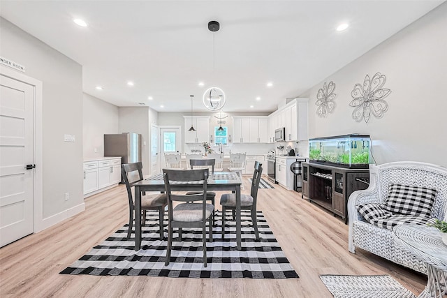 807 Ave J Pl, Conroe, TX 77301 - dining area with light wood-style floors and recessed lighting