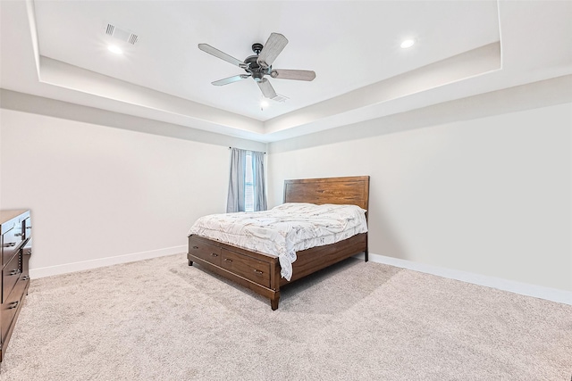 807 Ave J Pl, Conroe, TX 77301 - bedroom with a tray ceiling, light carpet, a ceiling fan, and recessed lighting