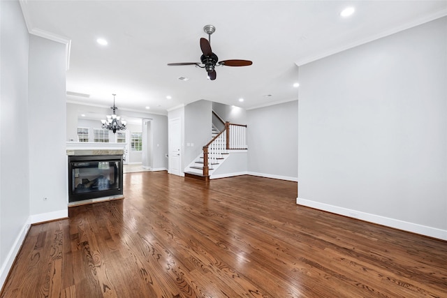 194 W Breezy Way, The Woodlands, TX 77380 - unfurnished living room with ornamental molding, stairway, ceiling fan, wood finished floors, and a chandelier