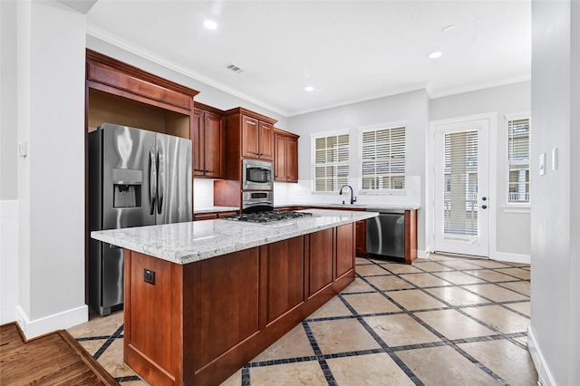 194 W Breezy Way, The Woodlands, TX 77380 - kitchen with stainless steel appliances, inlaid floor details, crown molding, tasteful backsplash, and recessed lighting