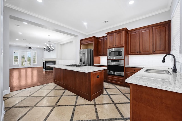 194 W Breezy Way, The Woodlands, TX 77380 - kitchen with decorative backsplash, appliances with stainless steel finishes, recessed lighting, a center island, and inlaid floor details