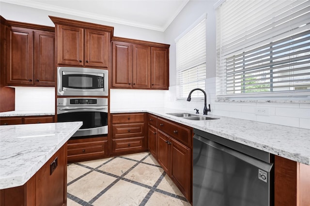 194 W Breezy Way, The Woodlands, TX 77380 - kitchen featuring inlaid floor details, appliances with stainless steel finishes, tasteful backsplash, light stone countertops, and crown molding
