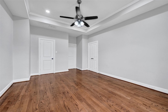 194 W Breezy Way, The Woodlands, TX 77380 - unfurnished bedroom featuring a raised ceiling, crown molding, wood finished floors, recessed lighting, and a ceiling fan