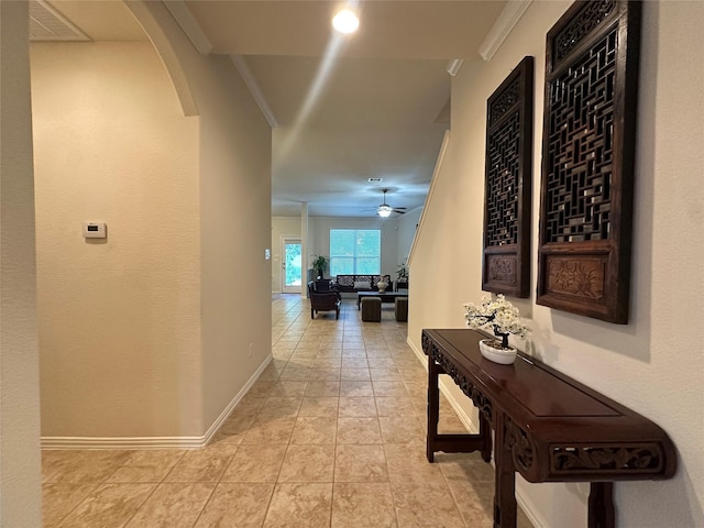 6818 Pear Point Ln, Richmond, TX 77469 - hallway with ornamental molding, arched walkways, and tile patterned floors