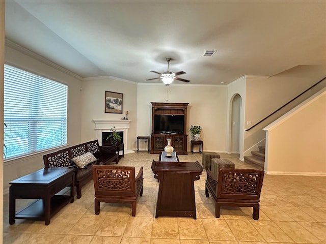 6818 Pear Point Ln, Richmond, TX 77469 - living area featuring a ceiling fan, crown molding, stairway, light tile patterned flooring, and arched walkways