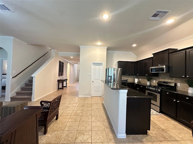 6818 Pear Point Ln, Richmond, TX 77469 - kitchen with appliances with stainless steel finishes, ornamental molding, light tile patterned floors, decorative backsplash, and arched walkways