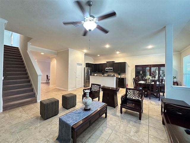 6818 Pear Point Ln, Richmond, TX 77469 - living area with arched walkways, a ceiling fan, ornamental molding, stairs, and light tile patterned floors