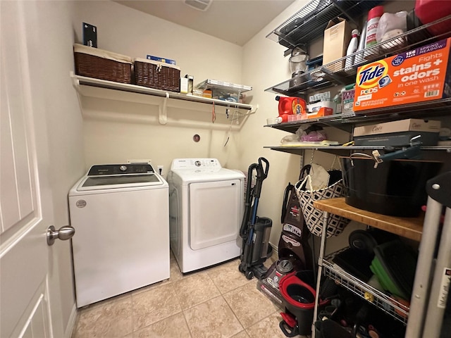 6818 Pear Point Ln, Richmond, TX 77469 - laundry area with washer and clothes dryer and light tile patterned floors