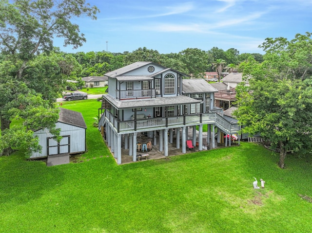7806 Burgess Rd, Hitchcock, TX 77563 - back of house with a storage unit, a lawn, a patio area, and a deck