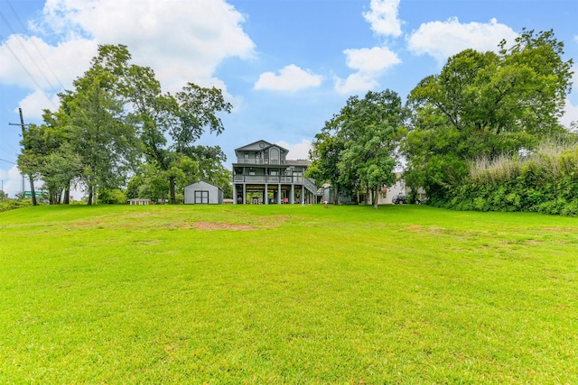 7806 Burgess Rd, Hitchcock, TX 77563 - view of green lawn with a shed, stairs, and a deck