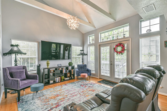 7806 Burgess Rd, Hitchcock, TX 77563 - living area with high vaulted ceiling, a chandelier, and wood finished floors