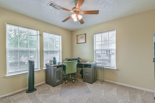 7806 Burgess Rd, Hitchcock, TX 77563 - office area featuring healthy amount of natural light, ceiling fan, light carpet, and a textured ceiling