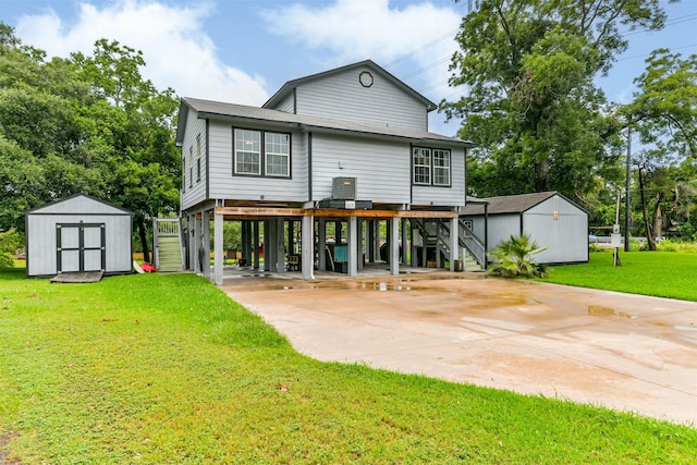 7806 Burgess Rd, Hitchcock, TX 77563 - rear view of property with a carport, stairs, a storage unit, driveway, and a yard