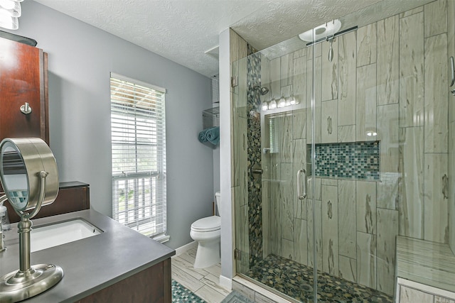 7806 Burgess Rd, Hitchcock, TX 77563 - full bathroom with vanity, a shower stall, and a textured ceiling