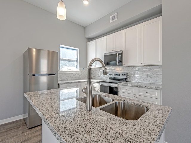8206 Tower St, Houston, TX 77088 - kitchen with stainless steel appliances, tasteful backsplash, white cabinets, and light stone counters