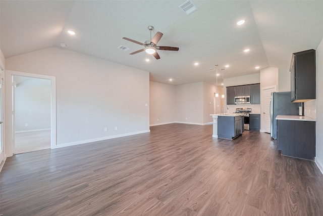 21830 Hickory Springs Ct, New Caney, TX 77357 - unfurnished living room featuring vaulted ceiling, ceiling fan, wood finished floors, and recessed lighting