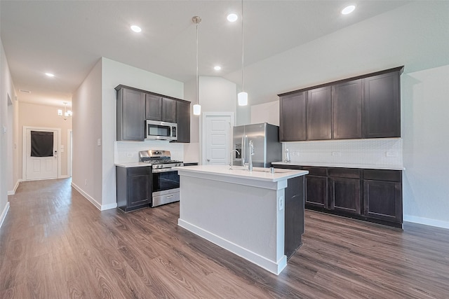 21830 Hickory Springs Ct, New Caney, TX 77357 - kitchen featuring dark wood finished floors, appliances with stainless steel finishes, decorative backsplash, and recessed lighting