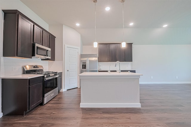 21830 Hickory Springs Ct, New Caney, TX 77357 - kitchen featuring stainless steel appliances, dark brown cabinetry, dark wood-style flooring, light countertops, and vaulted ceiling