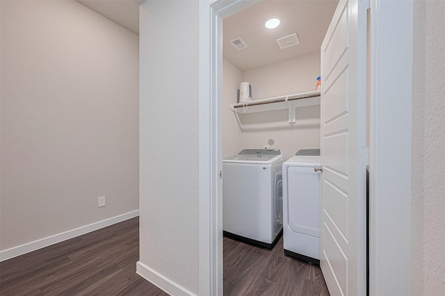 21830 Hickory Springs Ct, New Caney, TX 77357 - laundry room with dark wood-style flooring, separate washer and dryer, and a textured wall