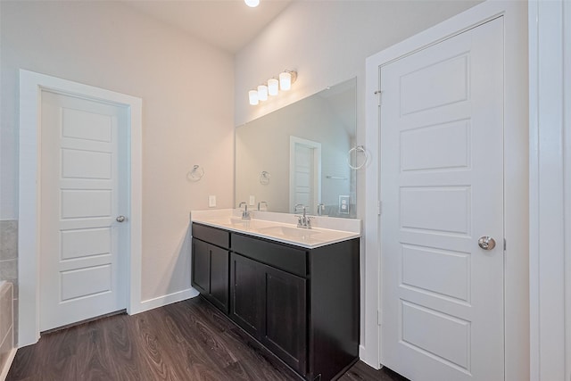 21830 Hickory Springs Ct, New Caney, TX 77357 - bathroom featuring wood finished floors and double vanity