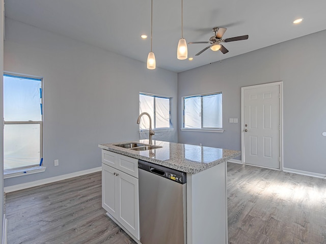 8201 Tower St, Houston, TX 77088 - kitchen featuring dishwasher, light wood-style floors, ceiling fan, white cabinetry, and pendant lighting