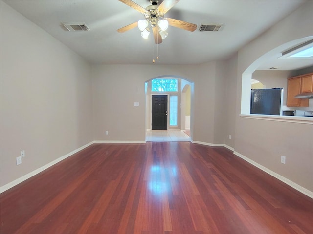 3511 Glenhill Dr, Pearland, TX 77584 - empty room with arched walkways, wood finished floors, and a ceiling fan