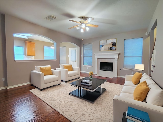 3511 Glenhill Dr, Pearland, TX 77584 - living room featuring ceiling fan, dark wood finished floors, arched walkways, and a fireplace