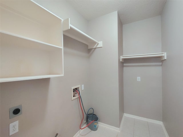 3511 Glenhill Dr, Pearland, TX 77584 - washroom with washer hookup, hookup for an electric dryer, a textured ceiling, and tile patterned floors