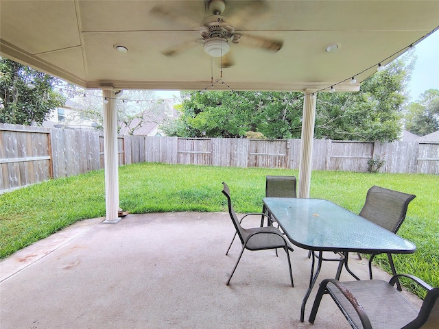 3511 Glenhill Dr, Pearland, TX 77584 - fenced backyard featuring a patio area, outdoor dining area, and a ceiling fan
