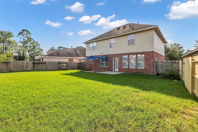 3502 Avalon Spring Ln, Spring, TX 77386 - back of property featuring brick siding, a patio area, and a fenced backyard