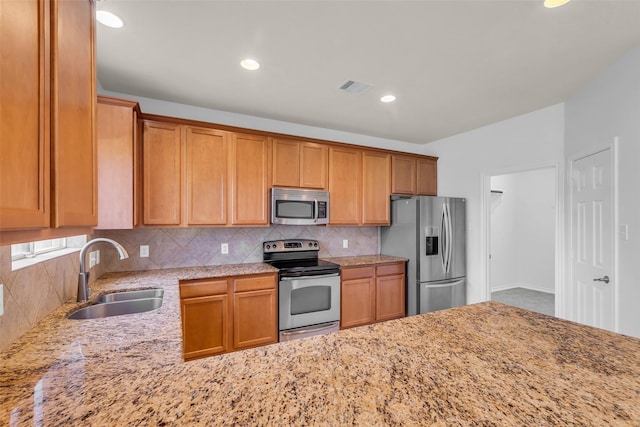 3502 Avalon Spring Ln, Spring, TX 77386 - kitchen with stainless steel appliances, tasteful backsplash, light stone counters, recessed lighting, and brown cabinets