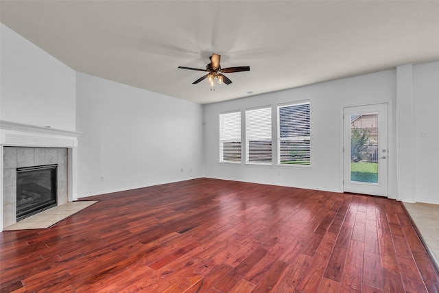 3502 Avalon Spring Ln, Spring, TX 77386 - unfurnished living room with wood finished floors, a tiled fireplace, and a ceiling fan