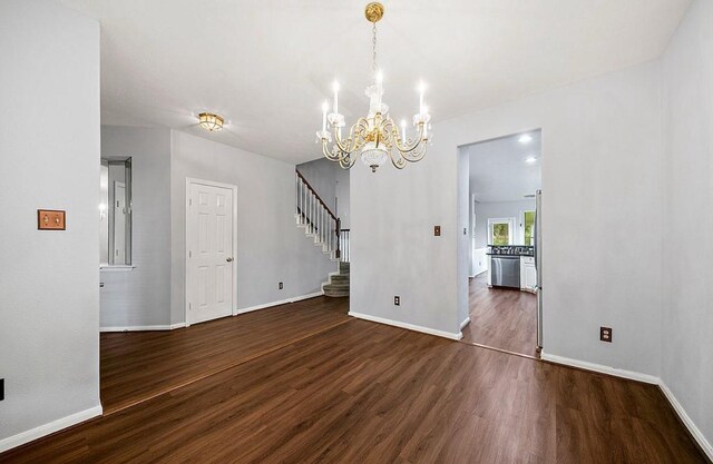 1123 Woodley Bnd, Sugar Land, TX 77479 - unfurnished dining area featuring dark wood-style floors, a chandelier, and stairs