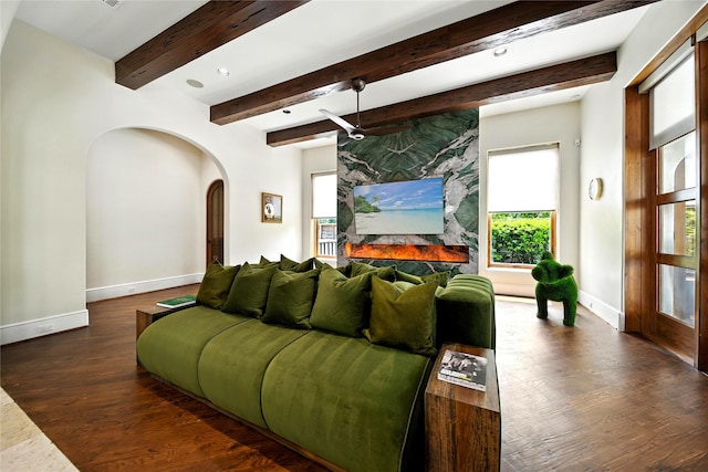 701 W Friar Tuck Ln, Houston, TX 77024 - living room with arched walkways, healthy amount of natural light, wood finished floors, ceiling fan, and beam ceiling