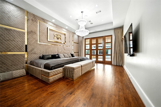 701 W Friar Tuck Ln, Houston, TX 77024 - bedroom with recessed lighting, wood finished floors, a tray ceiling, and access to exterior
