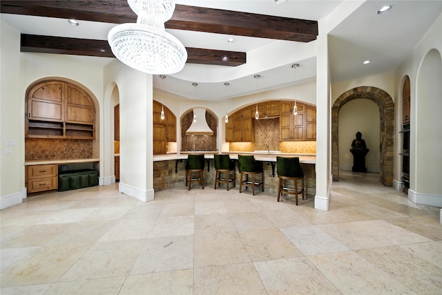 701 W Friar Tuck Ln, Houston, TX 77024 - kitchen with light countertops, recessed lighting, tasteful backsplash, arched walkways, and a kitchen bar
