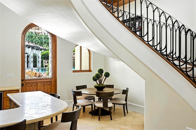 701 W Friar Tuck Ln, Houston, TX 77024 - dining room featuring stairs and light tile patterned floors