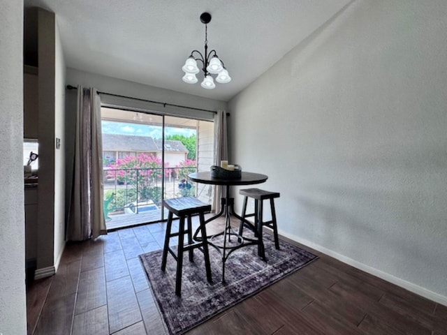 2211 S Kirkwood Rd Unit 35, Houston, TX 77077 - dining space with a chandelier, wood finished floors, vaulted ceiling, and a textured wall