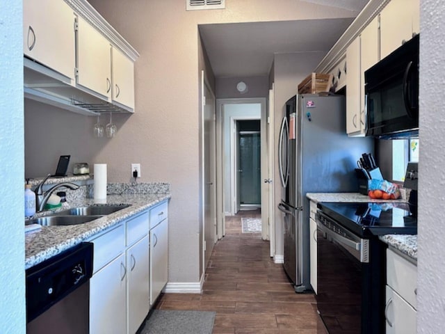2211 S Kirkwood Rd Unit 35, Houston, TX 77077 - kitchen featuring black appliances, dark wood finished floors, and white cabinetry